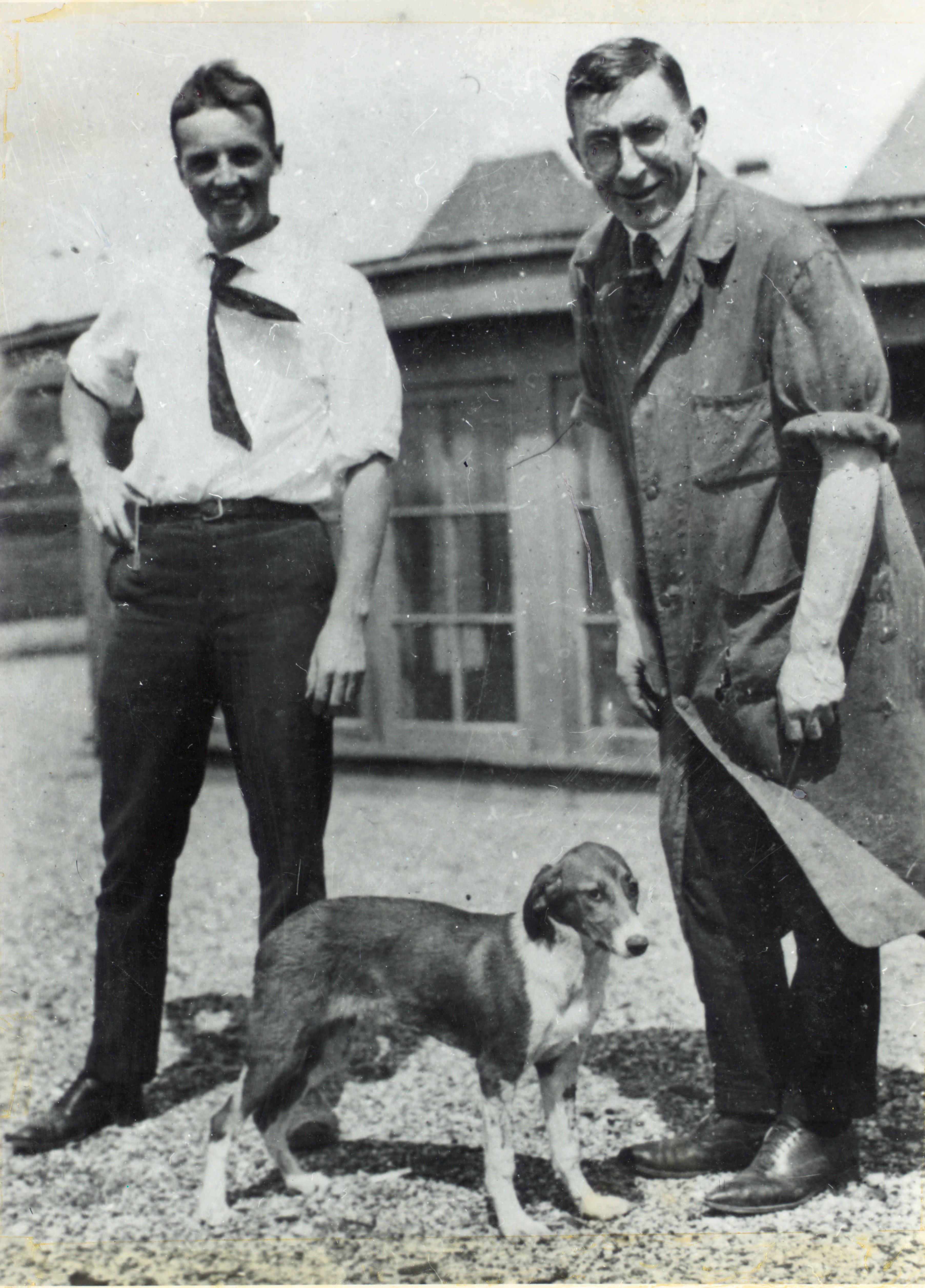 Frederick Banting, Charles Best and a dog standing on the roof of the Medical Building at the University of Toronto.