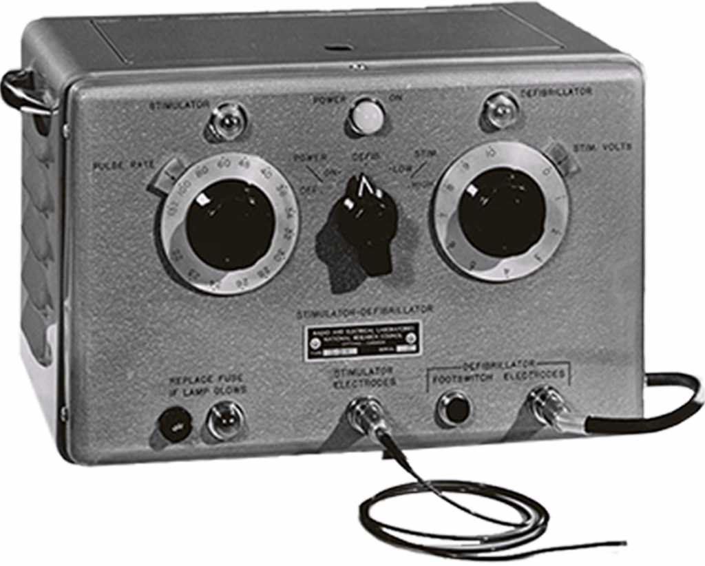 A black and white photograph of a small rectangular-shaped metal device with various knobs and dials on the front.