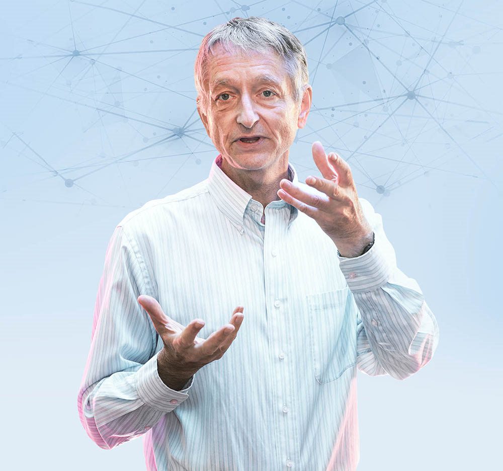 Geoffrey Hinton gestures while talking. Behind him is a drawing of a network of lines joined by many nodes.