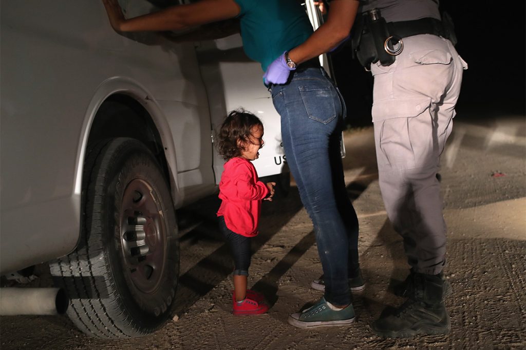 MCALLEN, TX - JUNE 12: A two-year-old Honduran asylum seeker cries as her mother is searched and detained near the U.S.-Mexico border on June 12, 2018 in McAllen, Texas