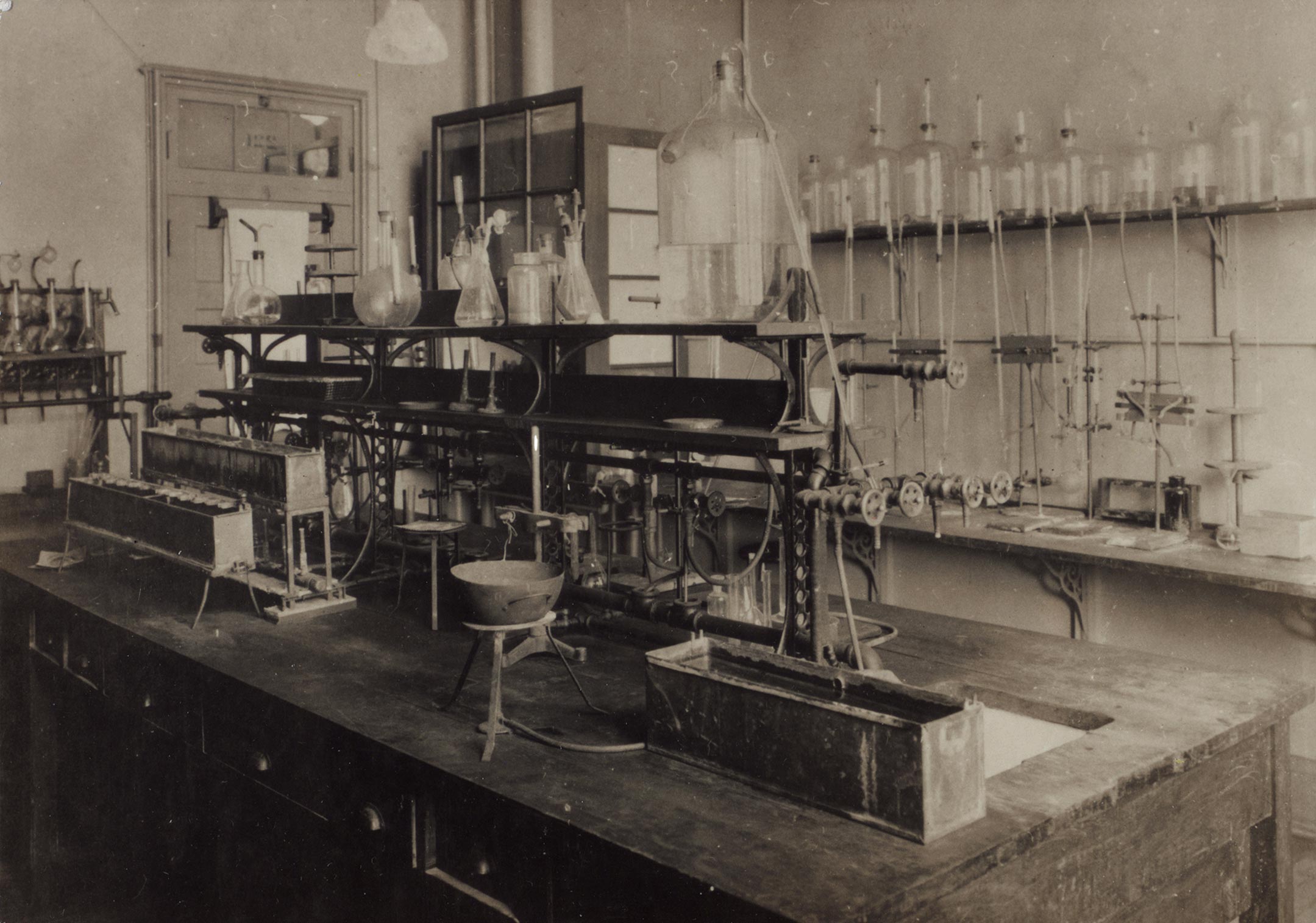 The lab where insulin was discovered: a wooden workbench filled with instruments, and a wall lined with bottles and tubing.